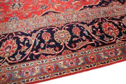 Backside of handmade 2000s Kashan rug showing knot structure and weave density