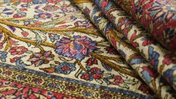Corner detail of 1920s Kashan rug showing border pattern and Silk pile