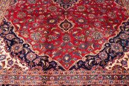 Corner detail of 1990s Kashan rug showing border pattern and Wool pile
