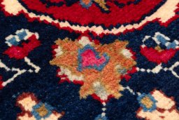 Backside of handmade 1990s Kashan rug showing knot structure and weave density
