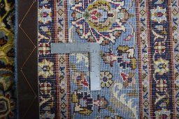 Backside of handmade 2000s Kashmar rug showing knot structure and weave density