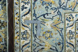 Backside of handmade 2000s Kashmar rug showing knot structure and weave density