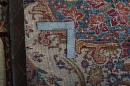 Backside of handmade 2000s Kashmar rug showing knot structure and weave density