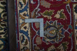 Backside of handmade 2000s Kashmar rug showing knot structure and weave density