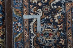 Backside of handmade 2000s Kashmar rug showing knot structure and weave density