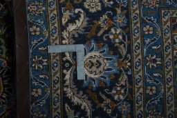 Backside of handmade 2000s Kashmar rug showing knot structure and weave density