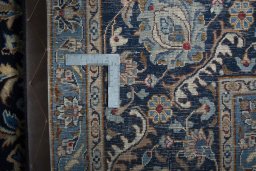 Backside of handmade 2000s Kashmar rug showing knot structure and weave density