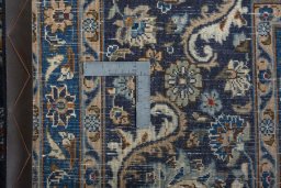 Backside of handmade 2000s Kashmar rug showing knot structure and weave density