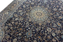 Backside of handmade 2000s Kashmar rug showing knot structure and weave density