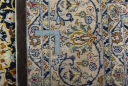 Backside of handmade 2000s Kashmar rug showing knot structure and weave density