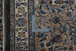 Backside of handmade 2000s Kashmar rug showing knot structure and weave density