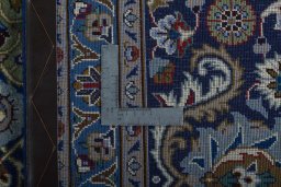 Backside of handmade 2000s Kashmar rug showing knot structure and weave density