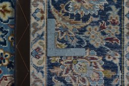 Backside of handmade 2000s Kashmar rug showing knot structure and weave density