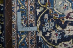 Backside of handmade 2000s Kashmar rug showing knot structure and weave density