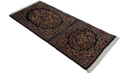 Close-up detail of 1980s Kerman rug from Iran / Persia showing Wool weave
