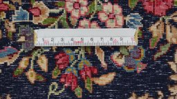 Backside of handmade 1970s Kerman rug showing knot structure and weave density
