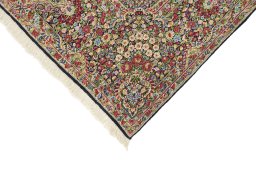 Backside of handmade 1970s Kerman rug showing knot structure and weave density
