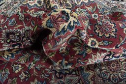 Surface texture of 2000s Kerman rug with natural Wool and intricate pattern