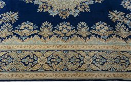 Corner detail of 2000s Kerman rug showing border pattern and Wool pile