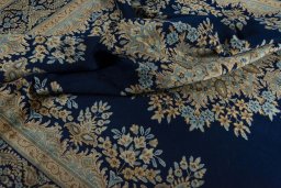 Surface texture of 2000s Kerman rug with natural Wool and intricate pattern