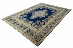 Corner detail of 2000s Kerman rug showing border pattern and Wool pile