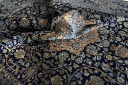 Backside of handmade 2000s Kerman rug showing knot structure and weave density