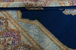 Close-up detail of 1970s Kerman rug from Iran / Persia showing Wool weave