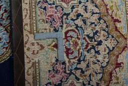 Backside of handmade 1970s Kerman rug showing knot structure and weave density