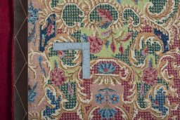 Backside of handmade 1950s Kerman rug showing knot structure and weave density
