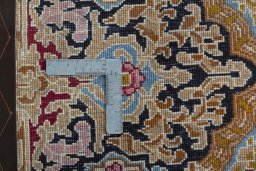 Backside of handmade 1970s Kerman rug showing knot structure and weave density