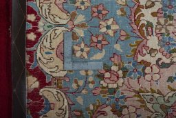 Backside of handmade 2000s Kerman rug showing knot structure and weave density