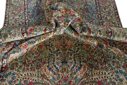 Surface texture of 2000s Kerman rug with natural Wool and intricate pattern