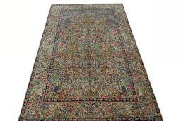 Surface texture of 2000s Kerman rug with natural Wool and intricate pattern
