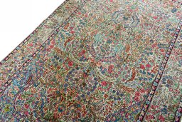 Backside of handmade 2000s Kerman rug showing knot structure and weave density