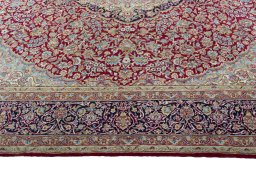Corner detail of 2000s Kerman rug showing border pattern and Wool pile