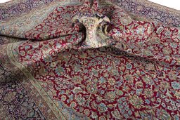 Surface texture of 2000s Kerman rug with natural Wool and intricate pattern