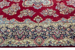 Corner detail of 2000s Kerman rug showing border pattern and Wool pile