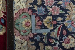 Backside of handmade 2000s Kerman rug showing knot structure and weave density