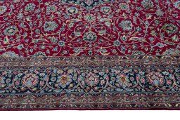 Corner detail of 2000s Kerman rug showing border pattern and Wool pile