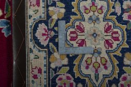 Backside of handmade 1970s Kerman rug showing knot structure and weave density