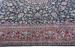 Corner detail of 2000s Kerman rug showing border pattern and Wool pile