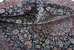 Surface texture of 2000s Kerman rug with natural Wool and intricate pattern