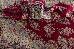 Surface texture of 2000s Kerman rug with natural Wool and intricate pattern