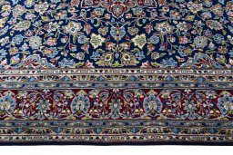 Corner detail of 2000s Kerman rug showing border pattern and Wool pile