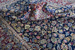 Surface texture of 2000s Kerman rug with natural Wool and intricate pattern