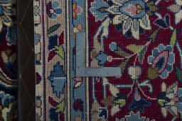 Backside of handmade 2000s Kerman rug showing knot structure and weave density