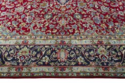 Corner detail of 2000s Kerman rug showing border pattern and Wool pile
