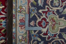 Backside of handmade 2000s Kerman rug showing knot structure and weave density