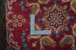 Backside of handmade 2000s Kerman rug showing knot structure and weave density