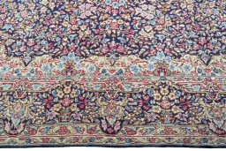 Corner detail of 1970s Kerman rug showing border pattern and Wool pile